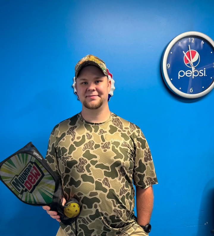 Summer giveaway winner holding Mountain Dew pickleball paddles at Pepsi Southwest Virginia